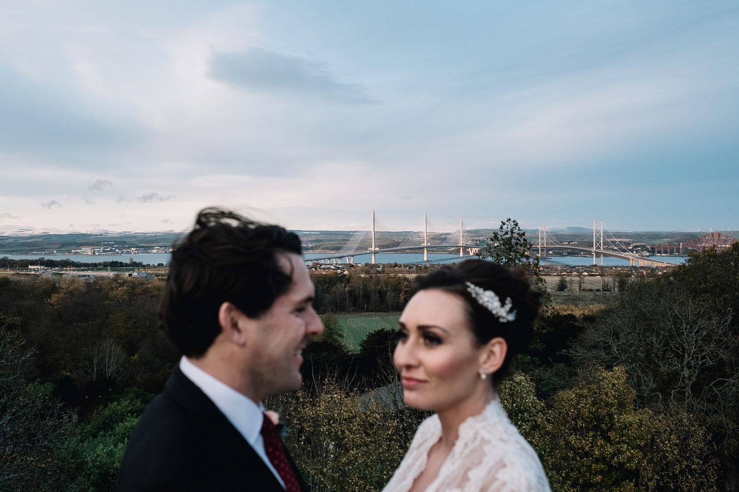  the two bridges are in focus from the rooftop of Dundas Castle's keep on their wedding day 