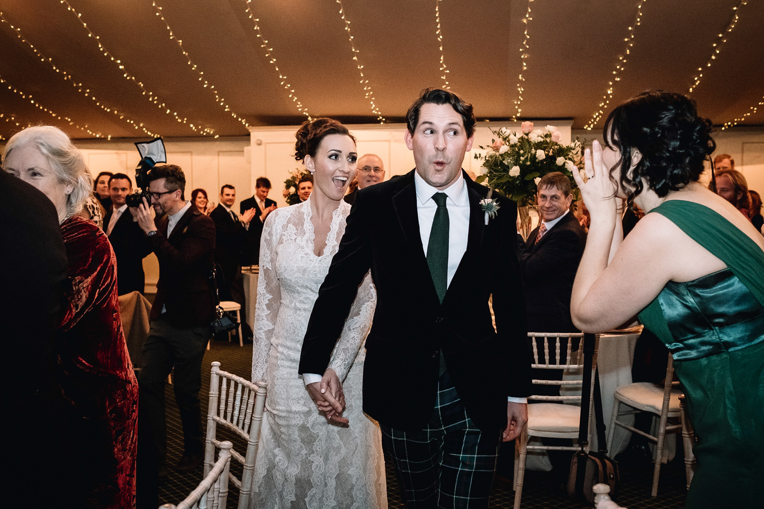  groom laughing as he and bride are received into their wedding reception at Dundas Castle 