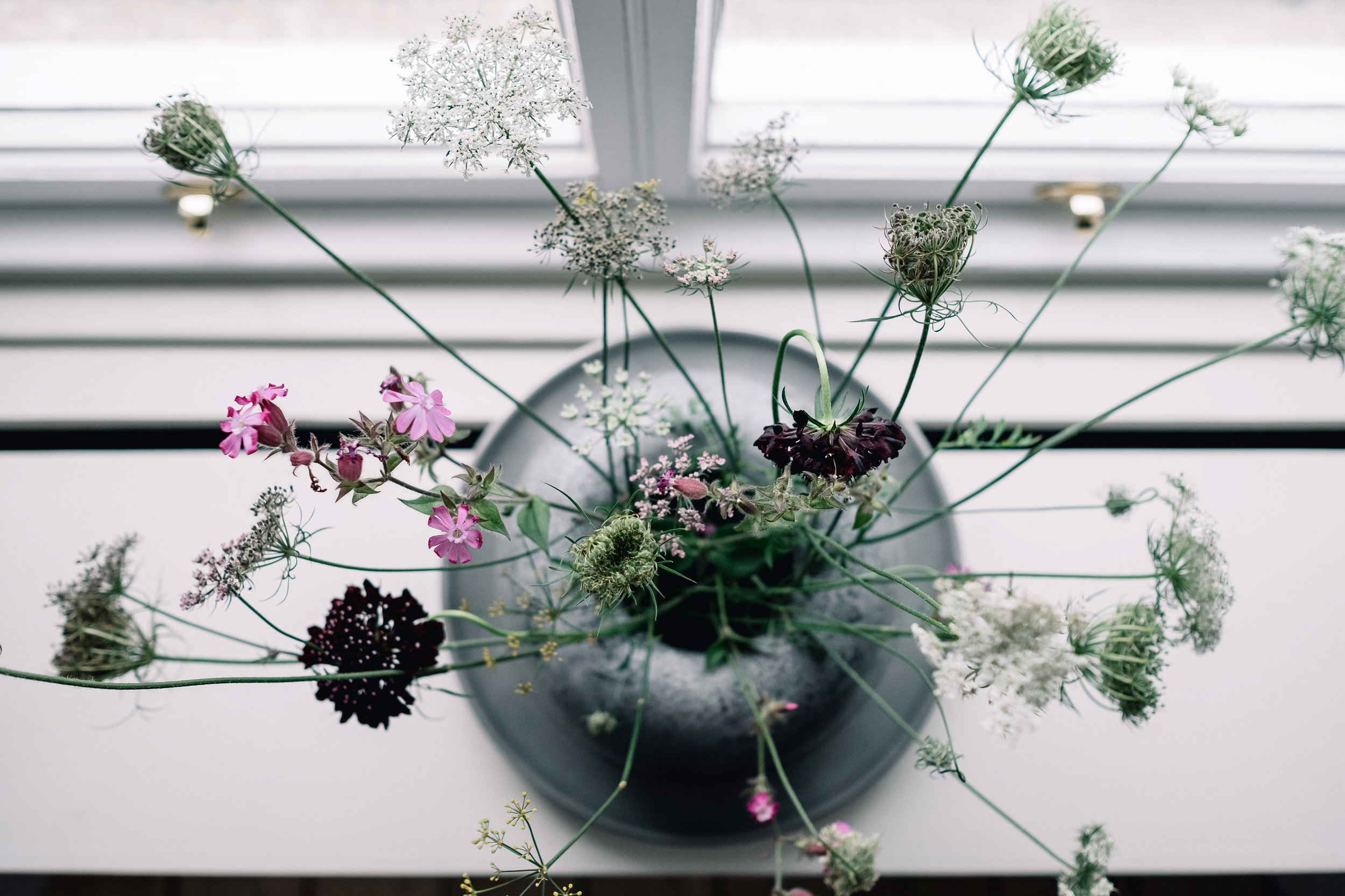 simple flower arragement on kitchen window shelf