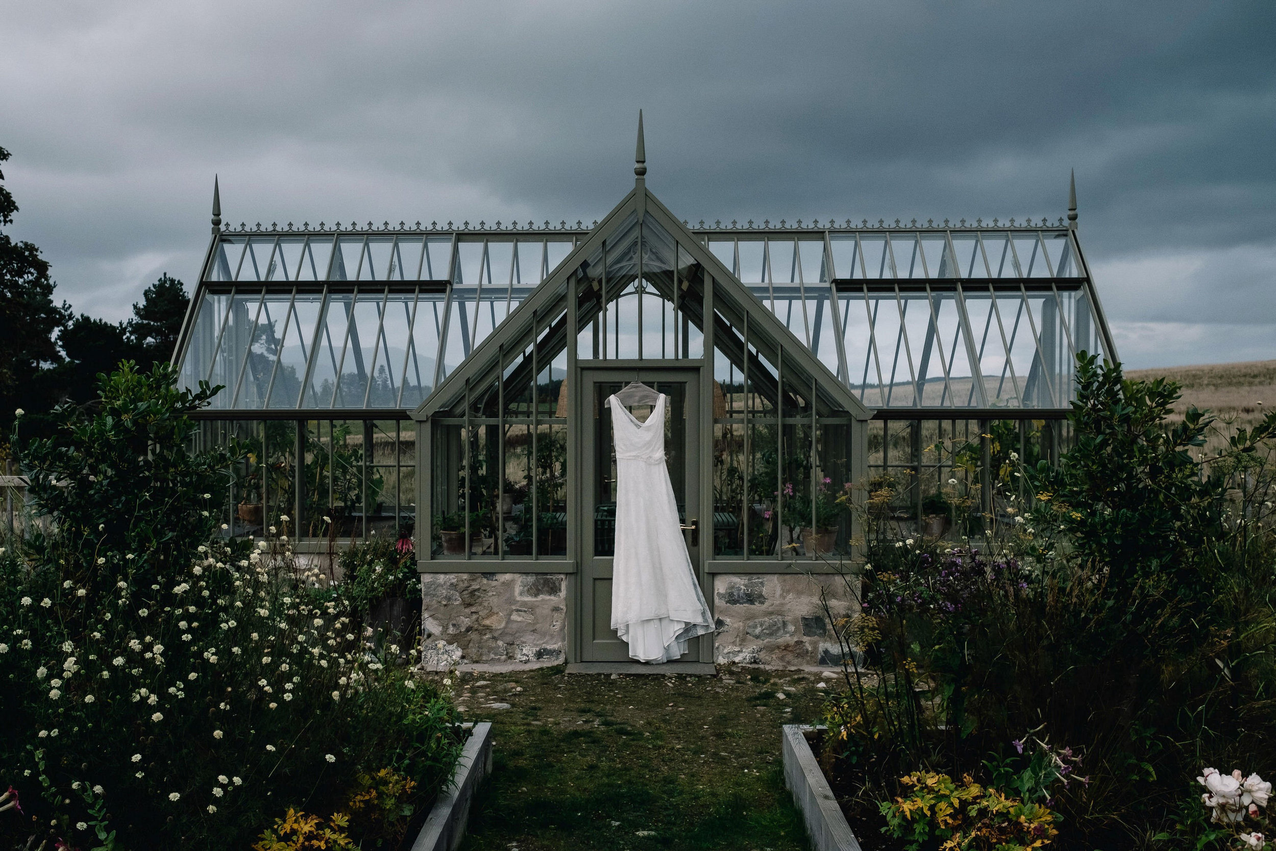  Wedding dress hangs from greenhouse on Killiehuntly Farmhouse. 