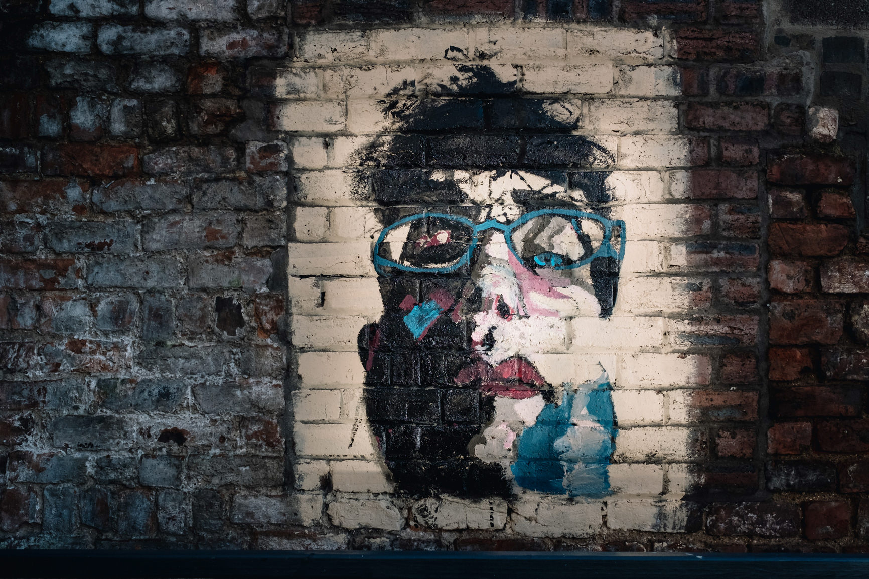 Grafitti on a brick wall in the outside area.