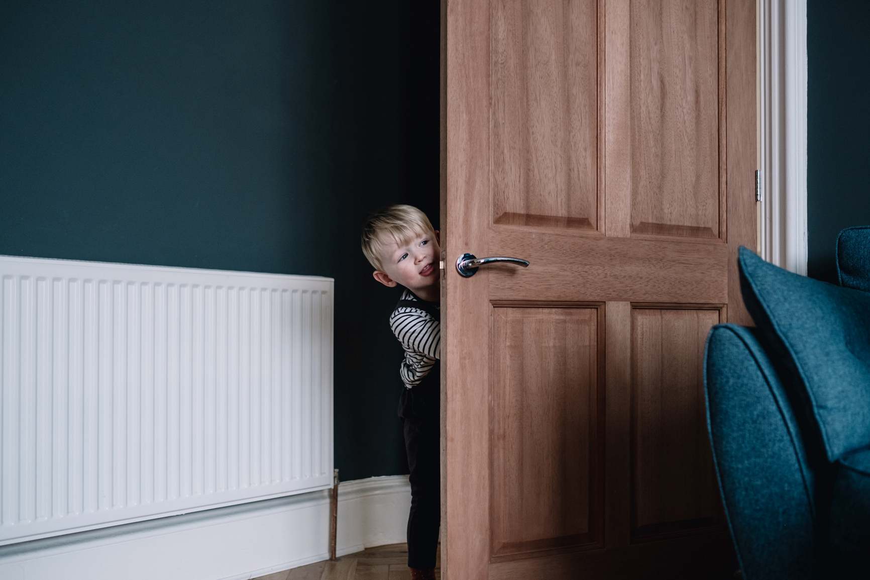  Child sticks head around the door. 