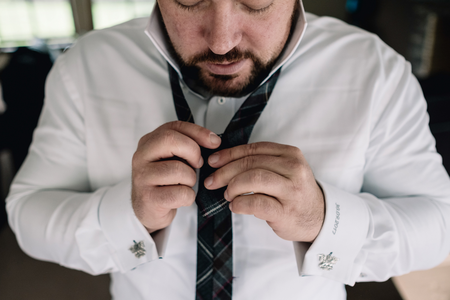  Groom fixing his tie. 