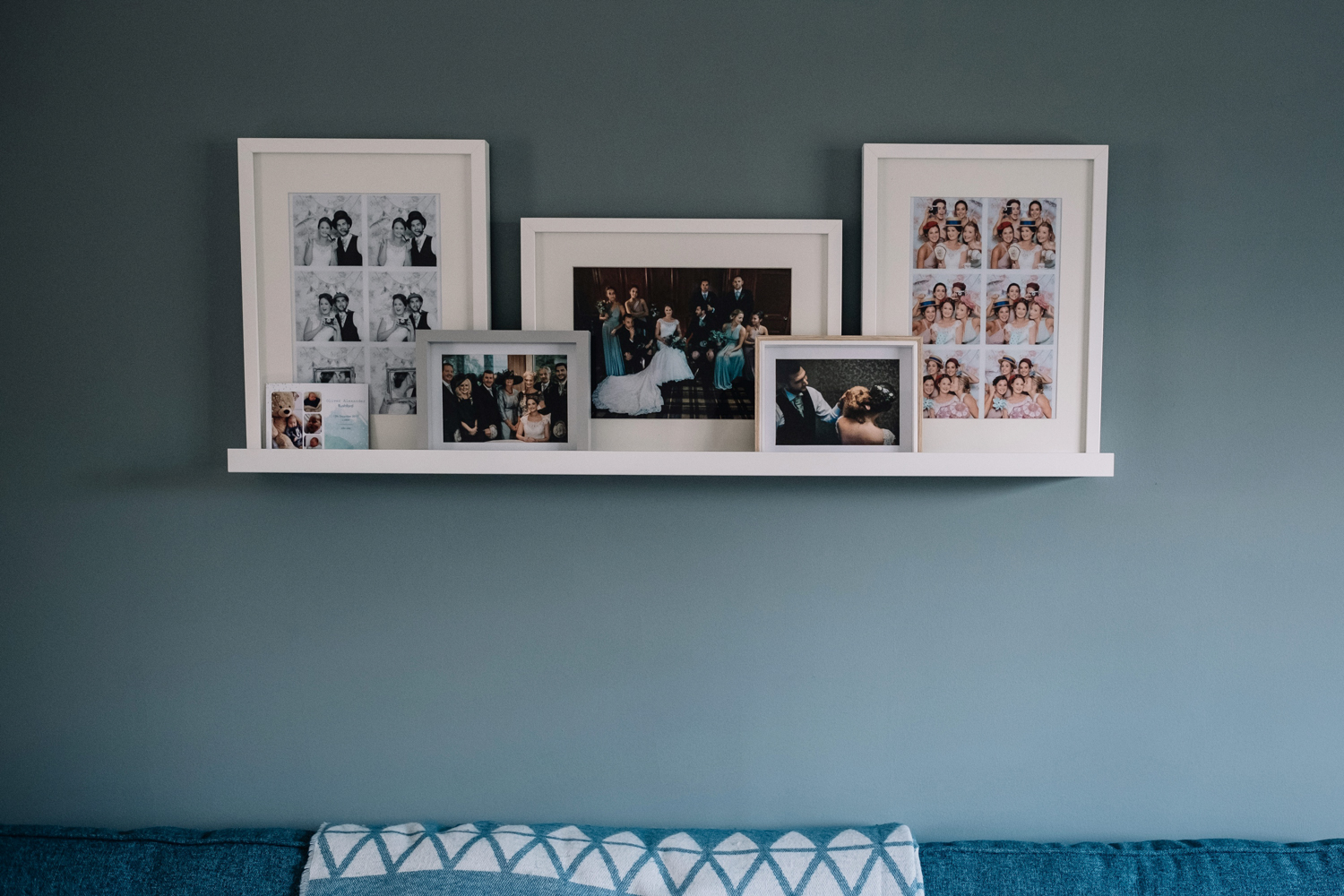  Living room wall featuring wedding photos of the couple's house. 