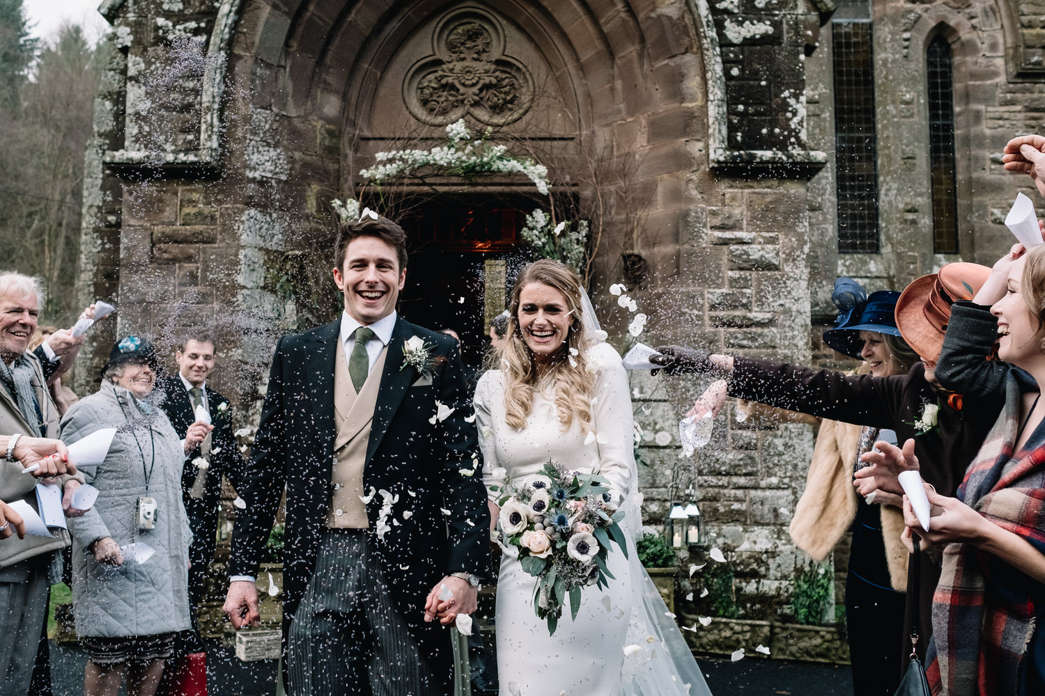  A smiling couple leave the church at Drumtochty Castle and are being covered in lavender. 