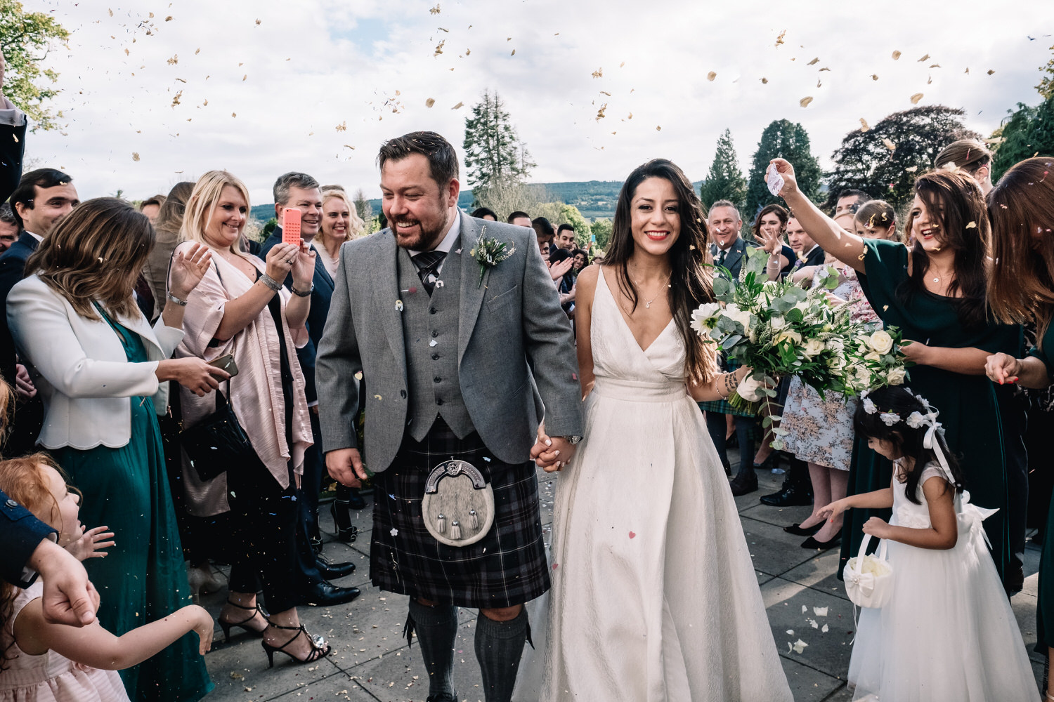  A couple laugh and run as they are showered with confetti. 