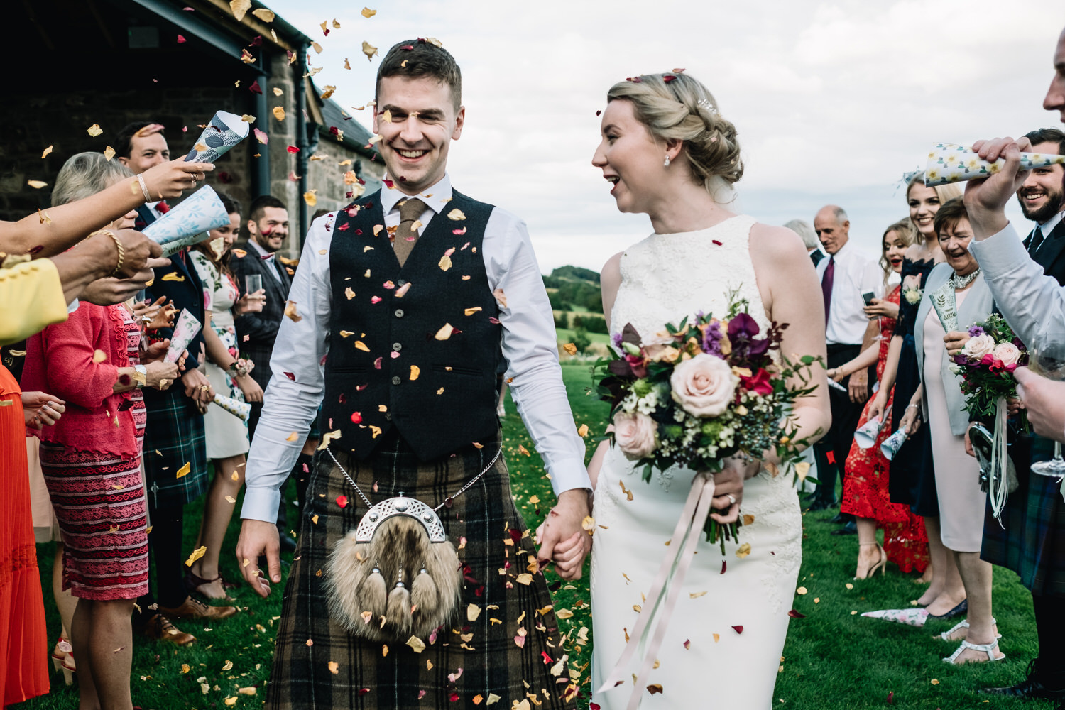  A couple enjoy the mass of confetti being showered on them by friends and family. 