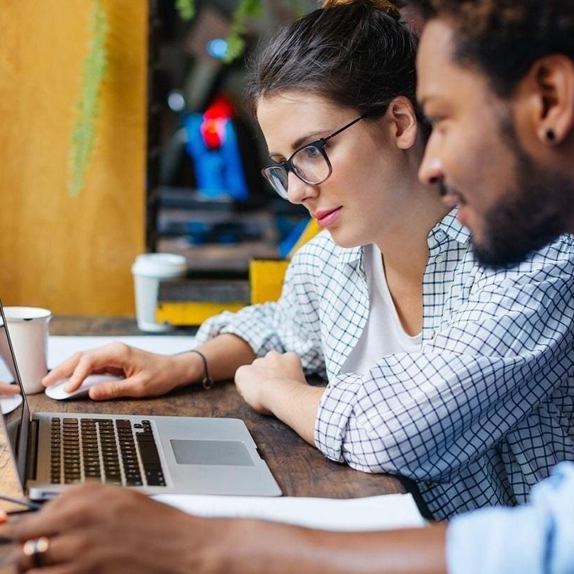 Two-people-collaborating-in-front-of-a-computer.jpg