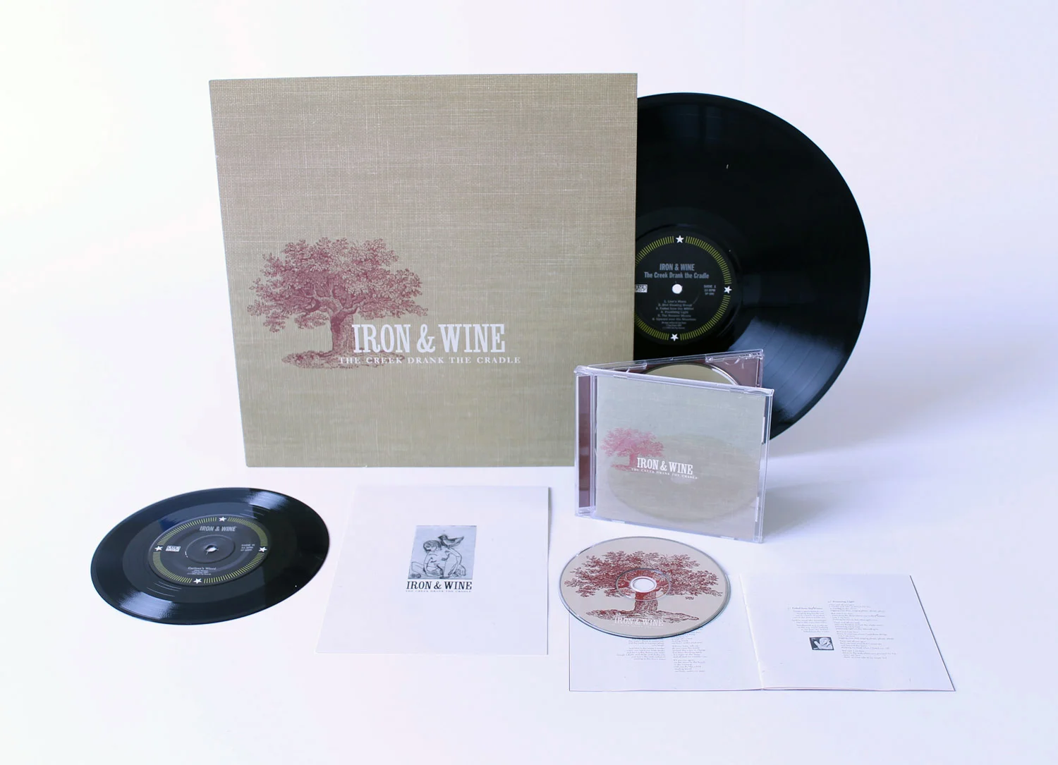 Iron &amp; Wine The Creek Drank the CradleThe debut album of a singer/songwriter whose songs sound like they’ve been tucked away in with a box of old books from a bygone era. My goal was to create a cover that looked like one of the neighboring book…