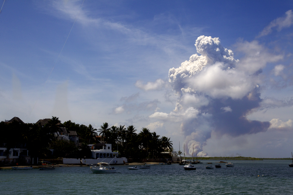 Plumes of smoke rise from the building site for Lamu Port. To the left is the idyllic fishing village of Shela, Lamu island. 