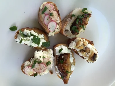 A spring Bruschetta plate, included grilled figs on top of Chevre (bottom) and Manchego (top right). 