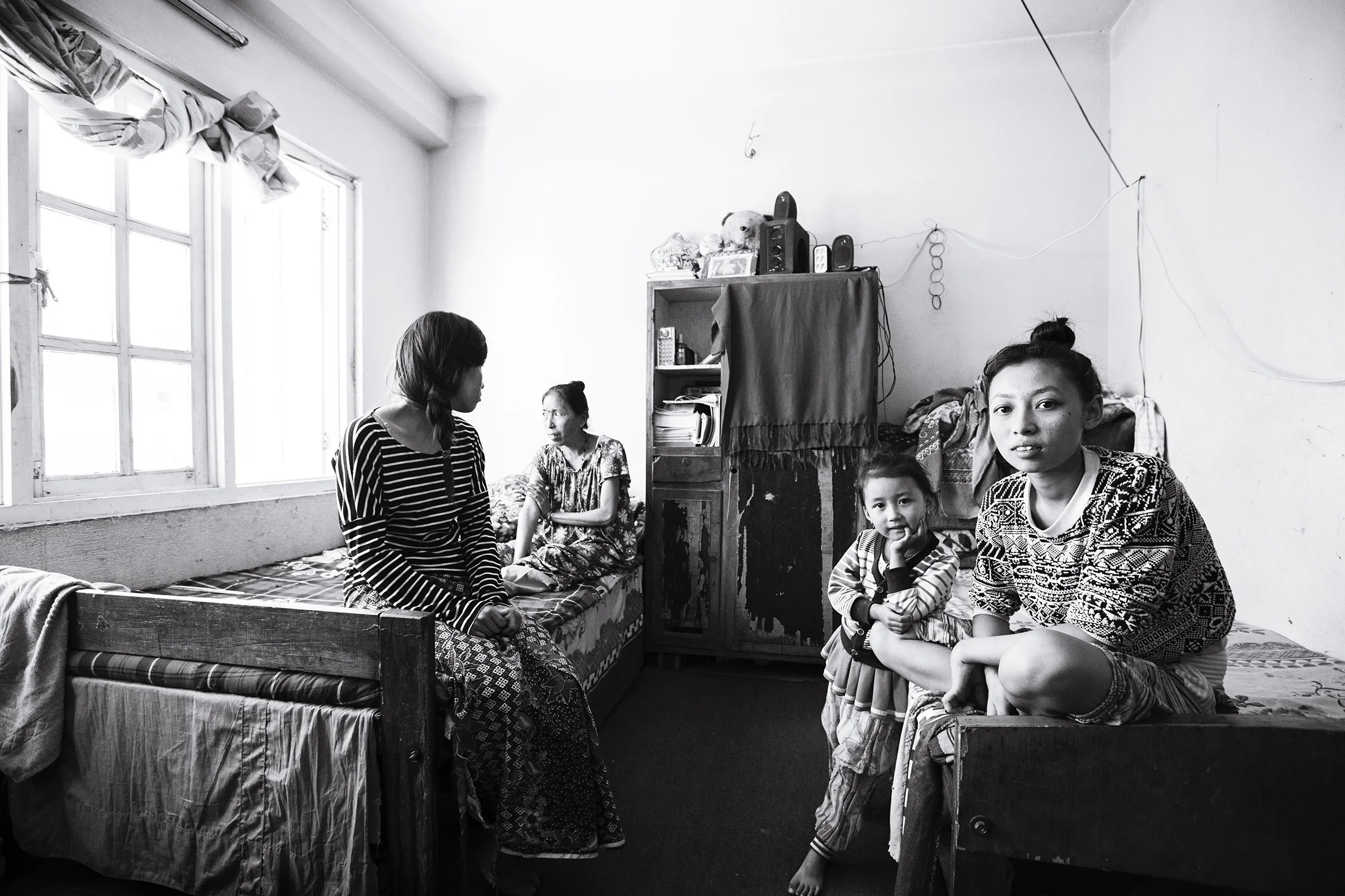 Anu's family within their single room home. Left to right: Anu (21), Phoolmaya (40s), Anjika (5), Anita (14). (not pictured: brother Anil (20).