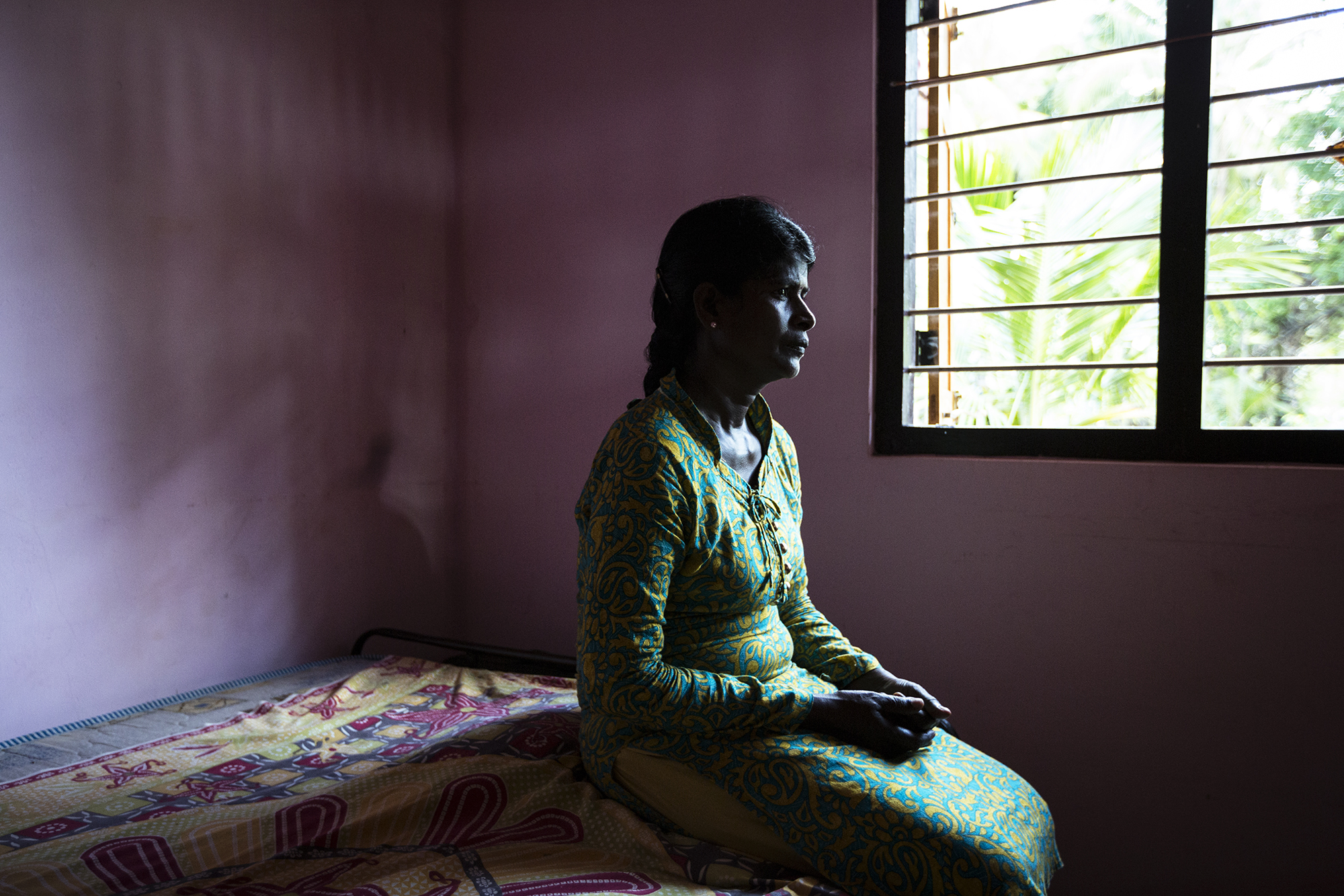 Iruthayarani, 36. Iruthayarani's husband was shot and killed in an open field while she was pregnant with their first child. She and her infant son lived in Cheddikulam displacement camp until they left the camp in 2012 to live on a small plot of jungle land allocated by the government. 