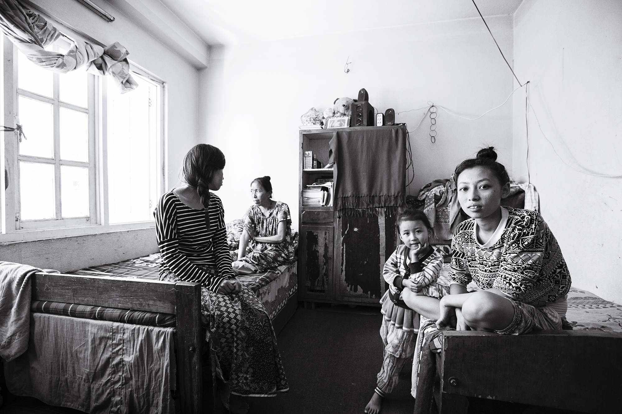  Anu (left) and her family lost their village home in the 2015 Nepal earthquake. The family relocated shortly after to a one room apartment in Kathmandu. 
