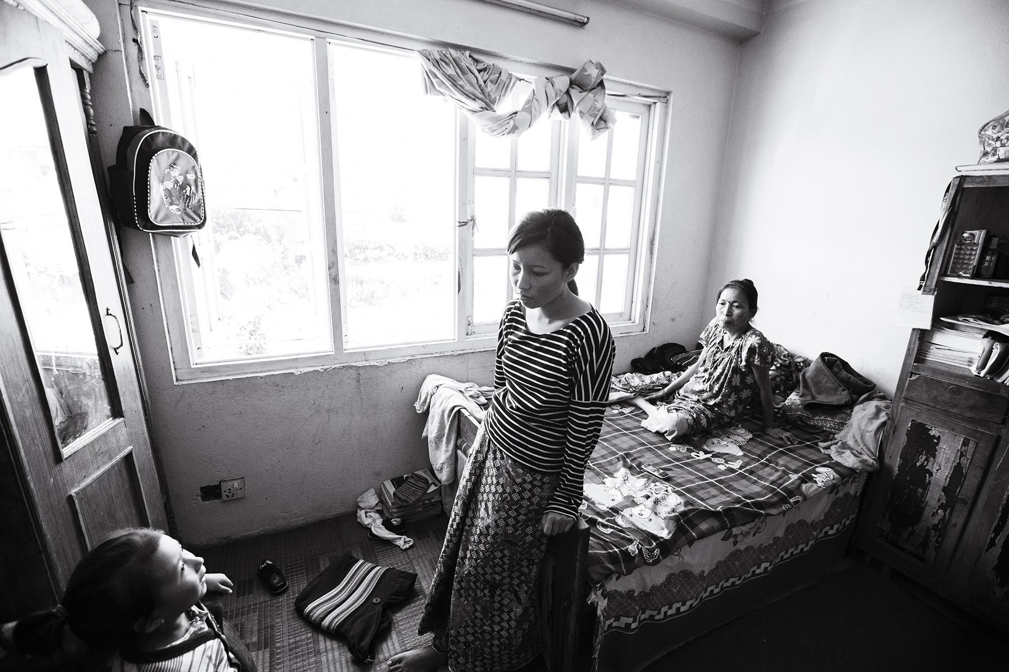  Anu stands in the room she shares with her mother, two sisters and one brother.&nbsp;  Anu's father left the family prior to the earthquake. Anu has spent the following months seeking a job to support the family and keep up with rent for the apartme