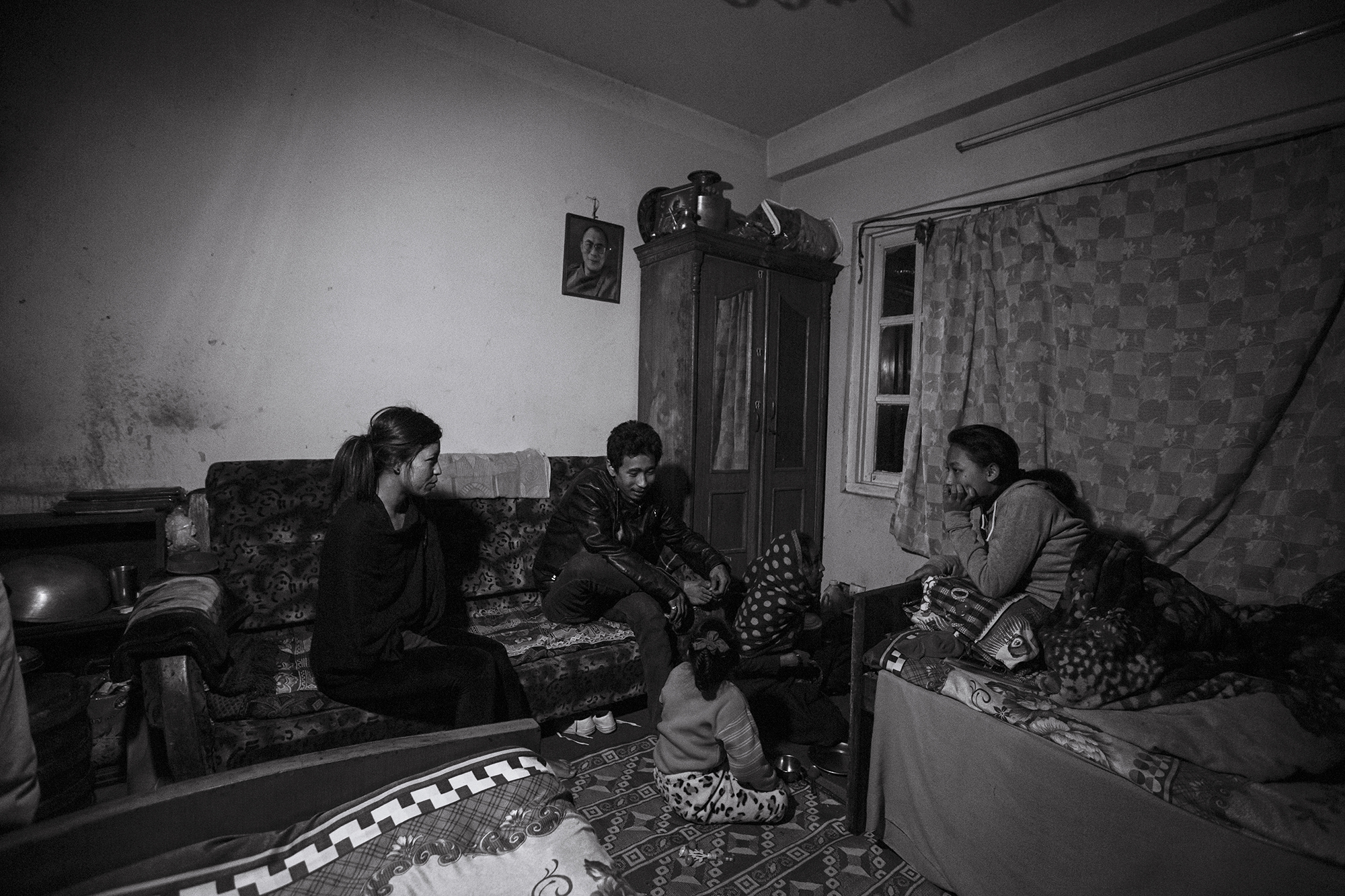The family gathers for dinner together the evening before Anu leaves Nepal. She has taken a job as a domestic worker in Cairo, Egypt, which will enable her to provide for her family by sending her monthly salary home.