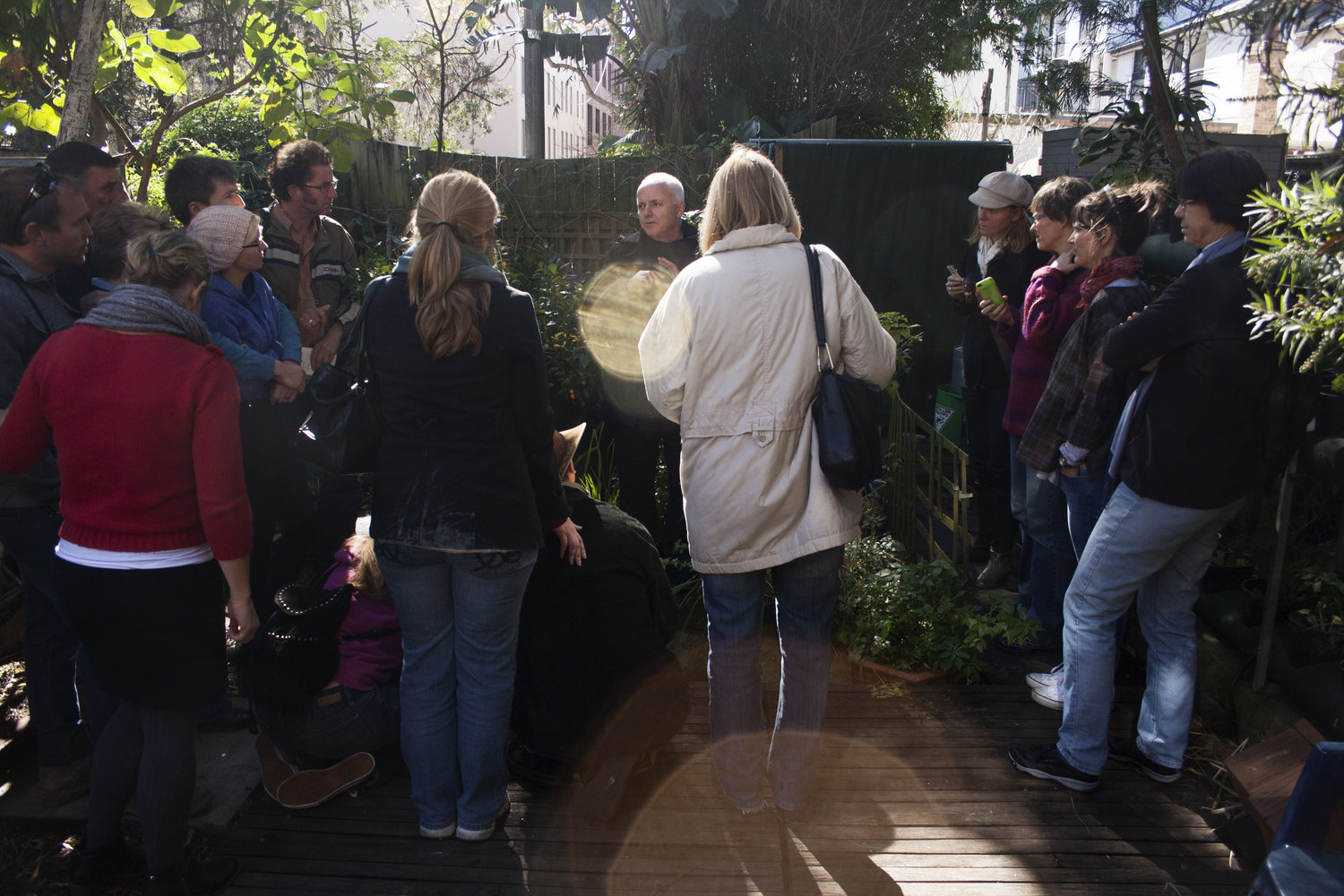 A tour group in the garden of Sydney's Sustainable House