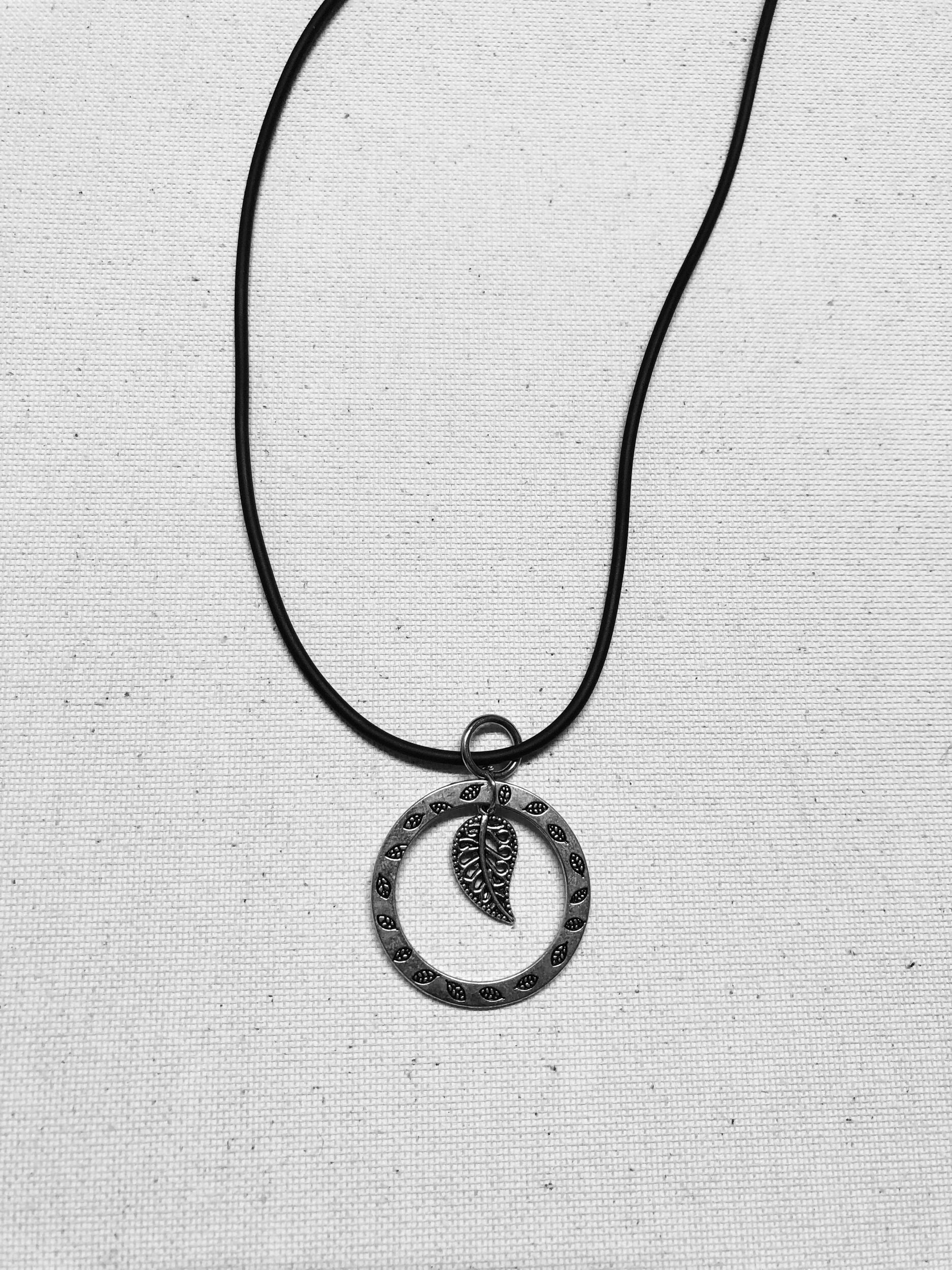 A leaf metal pendent cord necklace