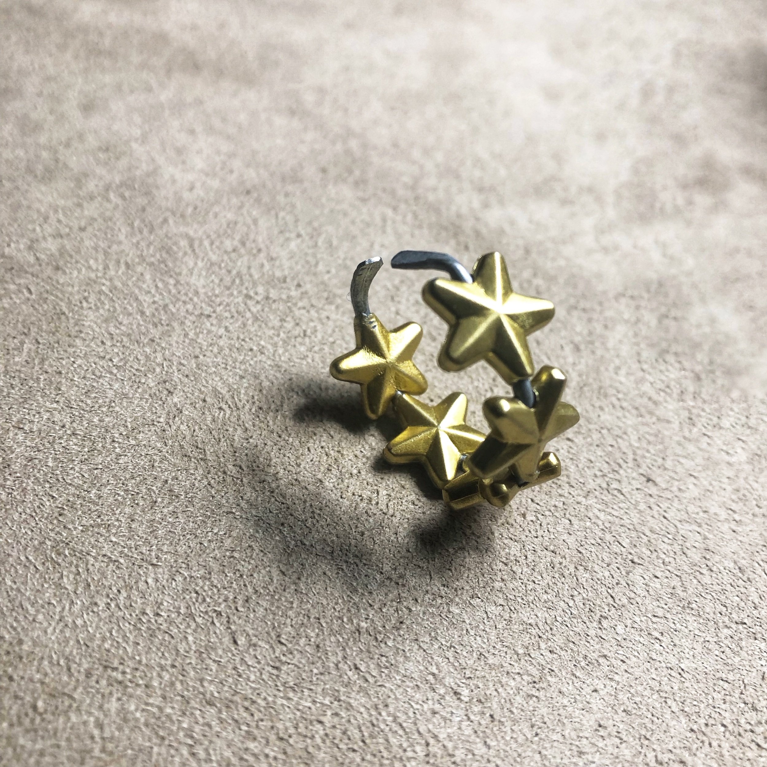 Multi-star open-wire cuff ring.