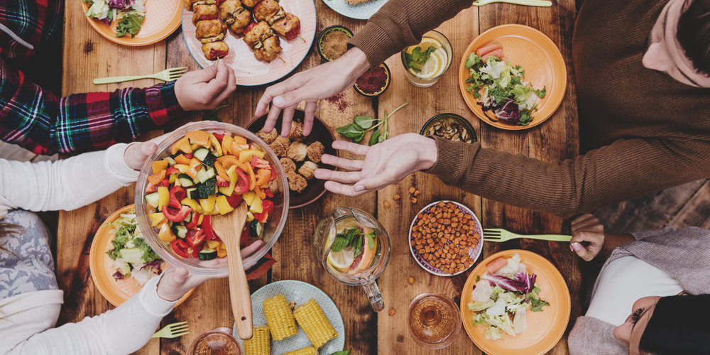 Friends having dinner. Top view of four people having dinner tog