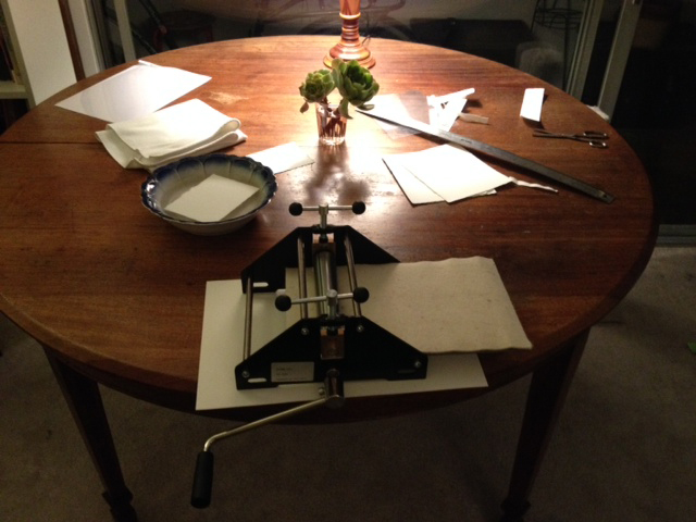 Printing on my family's old kitchen table. My Mom's summer cucumber salad bowl acting as paper soaking tray.