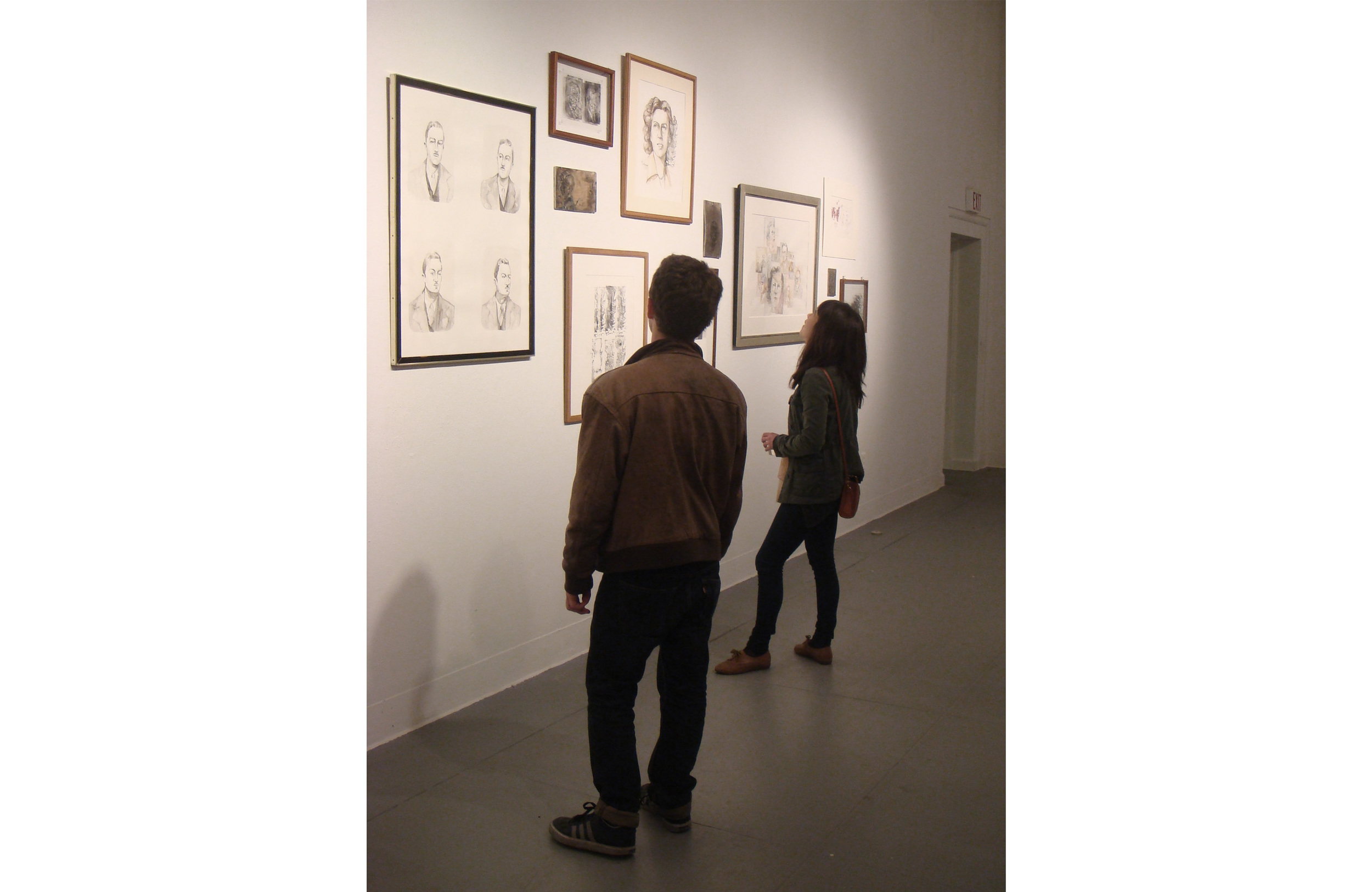  Salon gallery wall.&nbsp;Portraits are positioned at different levels, with mismatched frames, and smaller pieces — including the linoleum blocks from which the prints were made — hang in between larger works.&nbsp; 