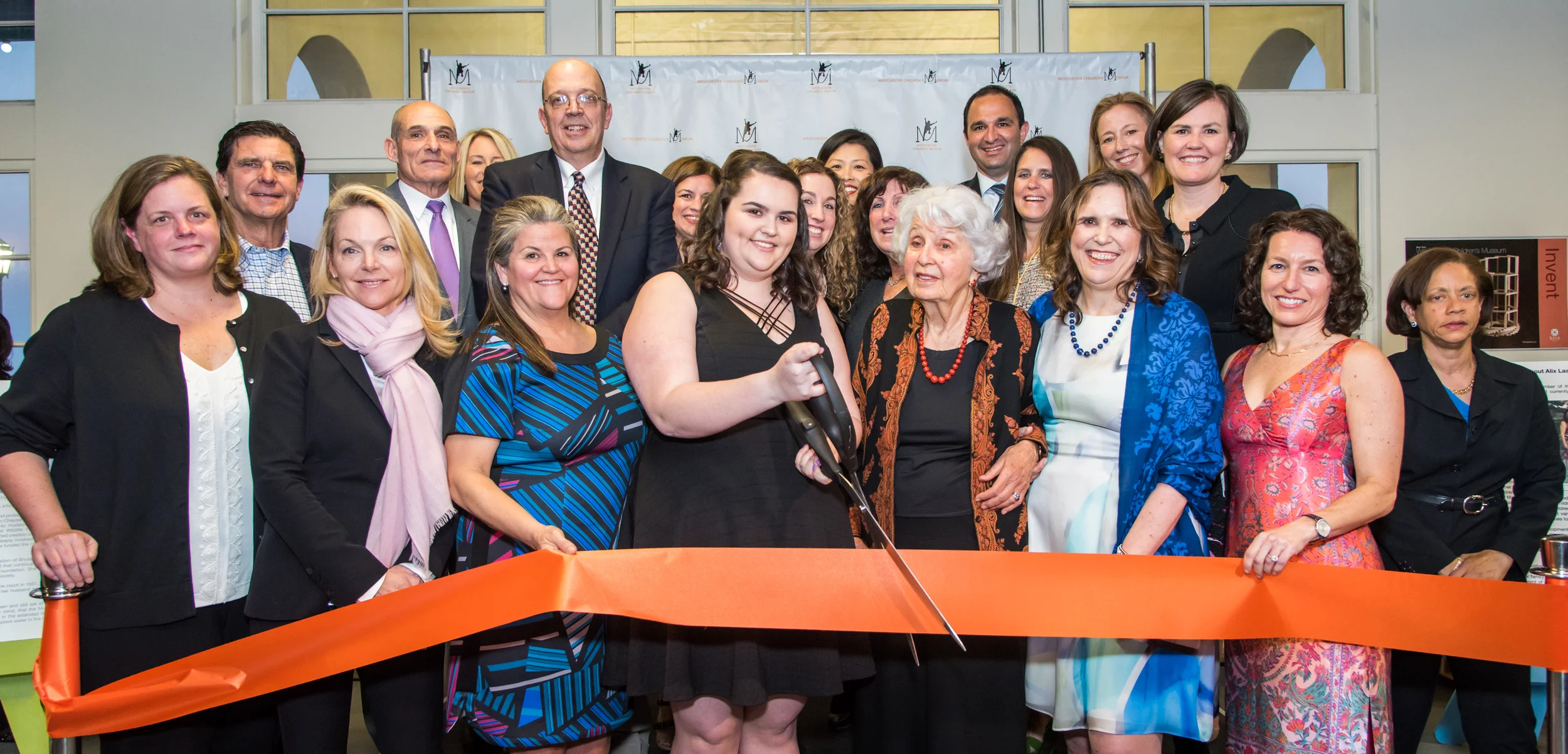 Current and founding boardmembers with Lisina Hoch cutting the ribbon to open the Hoch Laager Boardwalk Galleries, Phase 1 of the Westchester Children's Museum.