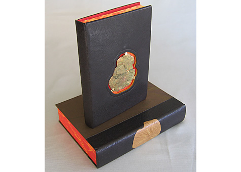 Binder: Sabina Nies: John Muir, Heaven on Earth. Press Intermezzo, Austin, Texas, 1998. Full leather brown goatskin binding in the French style. Pyrite insert on the front cover, with red leather full doublures; hand marbeled paper by Einen Miura. The clamshell box is half leather with onlay, marbled paper by the binder, and gold tooled title. The inside is lined with suede, with a recessed area to accommodate the pyrite on the book's cover. 