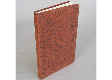  Binder: Lily Stevenson: Journal. The soft leather-bound blank book has handmade Iowa walnut fly leaves. The book block is Rives paper sewn on tapes. It is an experimental piece to see if embossed upholstery leather could be used to make a soft cover