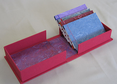  Binder: Lily Stevenson: Four Japanese Stab-bound Books in a Box. The red cloth-covered handmade box is lined with paper from Thailand. The set of four blank books is made from Thai mulberry paper. 