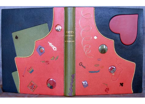  Eleanore Ramsey, "Alice's Adventures in Wonderland" by Lewis Carroll. Book covered in full teal French Cape morocco with a pink chagrin rabbit hole, in profile, extending onto front and back covers. Design represents Alice's fall through the rabbit 