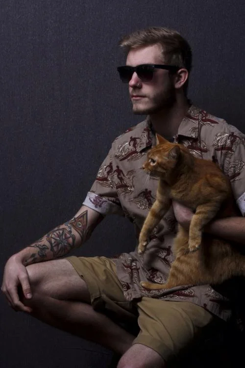 The only image from Facebook I could find that shows his tattoos..... and a cat.