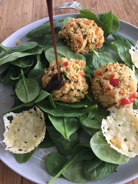 Zucchini fritters on a bed of organic spinach with parmesan crisps and a drizzle of fig balsamic.