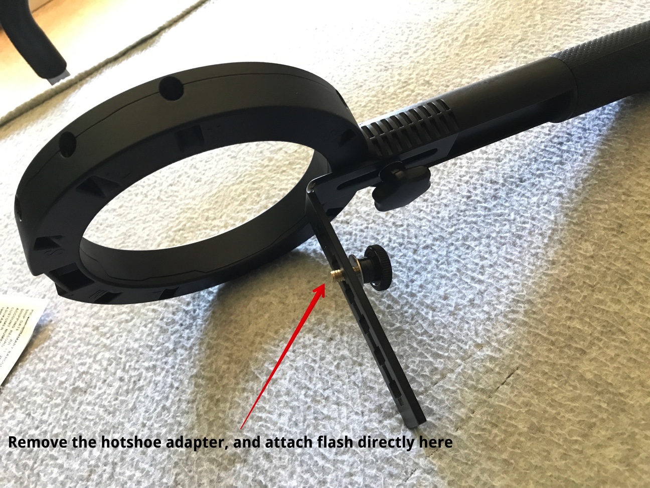 Remove the cold shoe and use the retaining bolt to connect your flash. The bracket can be adjusted vertically, flipped, or mounted using the lower holes for fitment to almost any light.