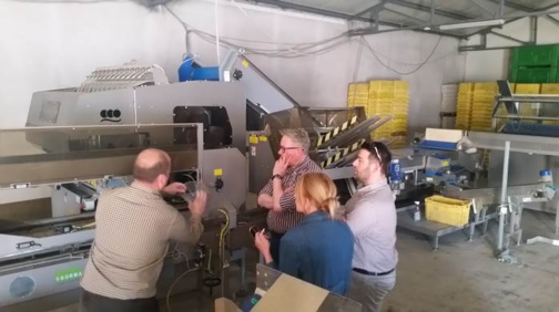 (ABOVE) Quality control measures are reviewed on a tour of the packing facility