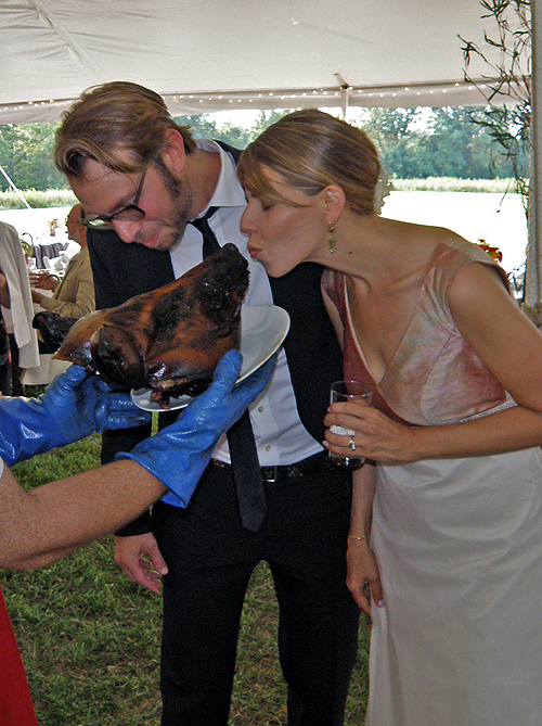 Lynn Peemoeller and Eric Ellingsen ceremoniously kiss the pig at their 2010 Shakertown wedding