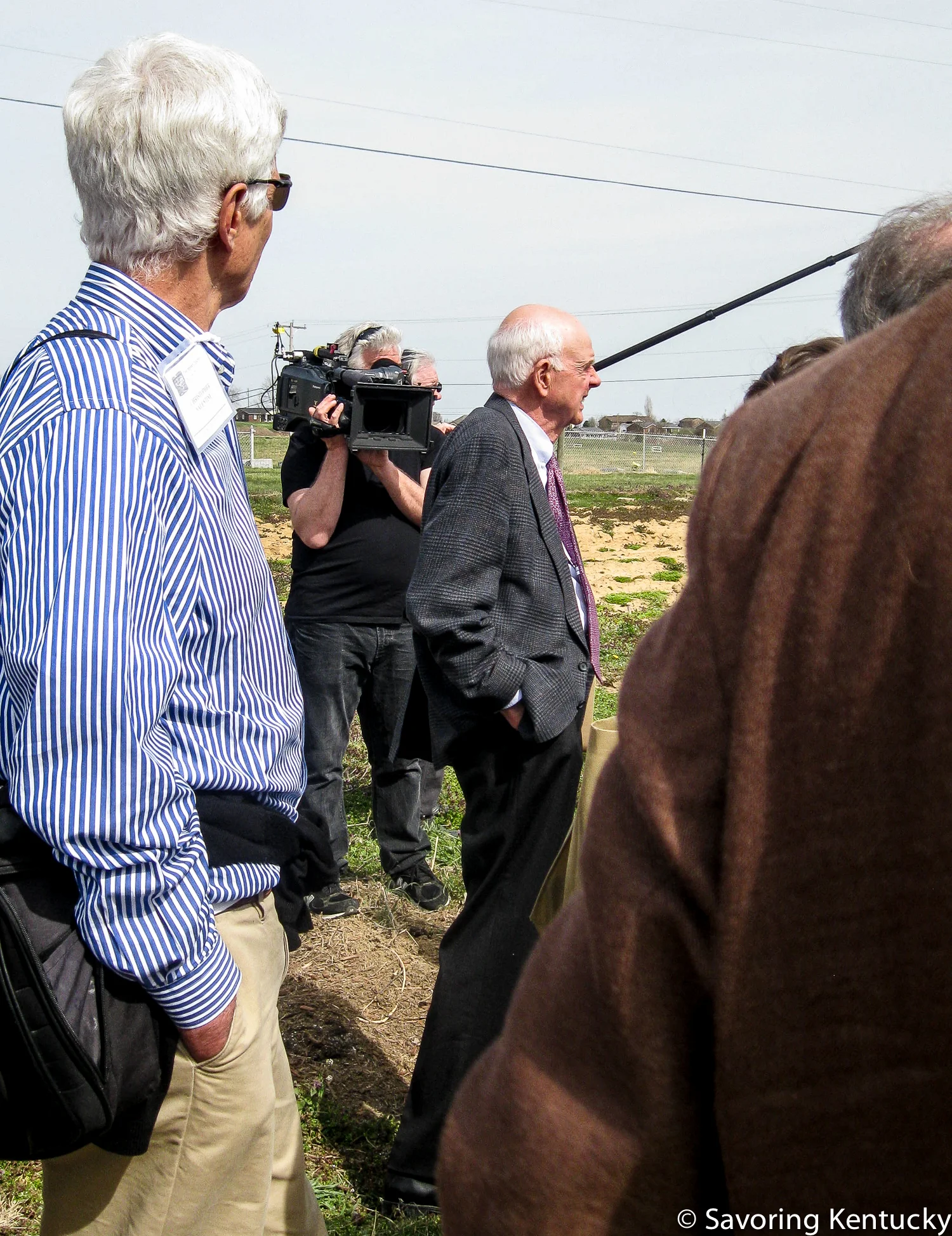 Wendell Berry, center, in a crowd of conference participants touring one site of the St. Catharine's unfolding Berry Farming and Ecological Agrarianism Program .