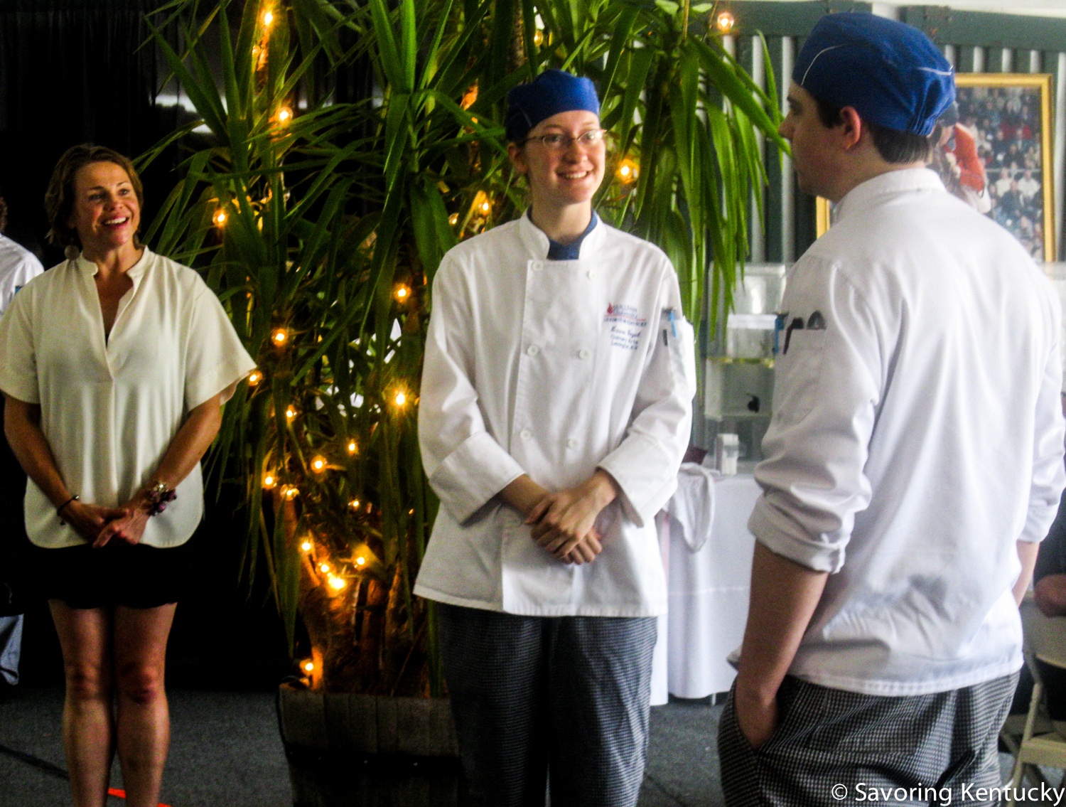 Crave Festival director Robbie Morgan, left, looks on as Sullivan student chefs Laura Vogel and Will Unseld describe their meal opening trio of smoked soups.