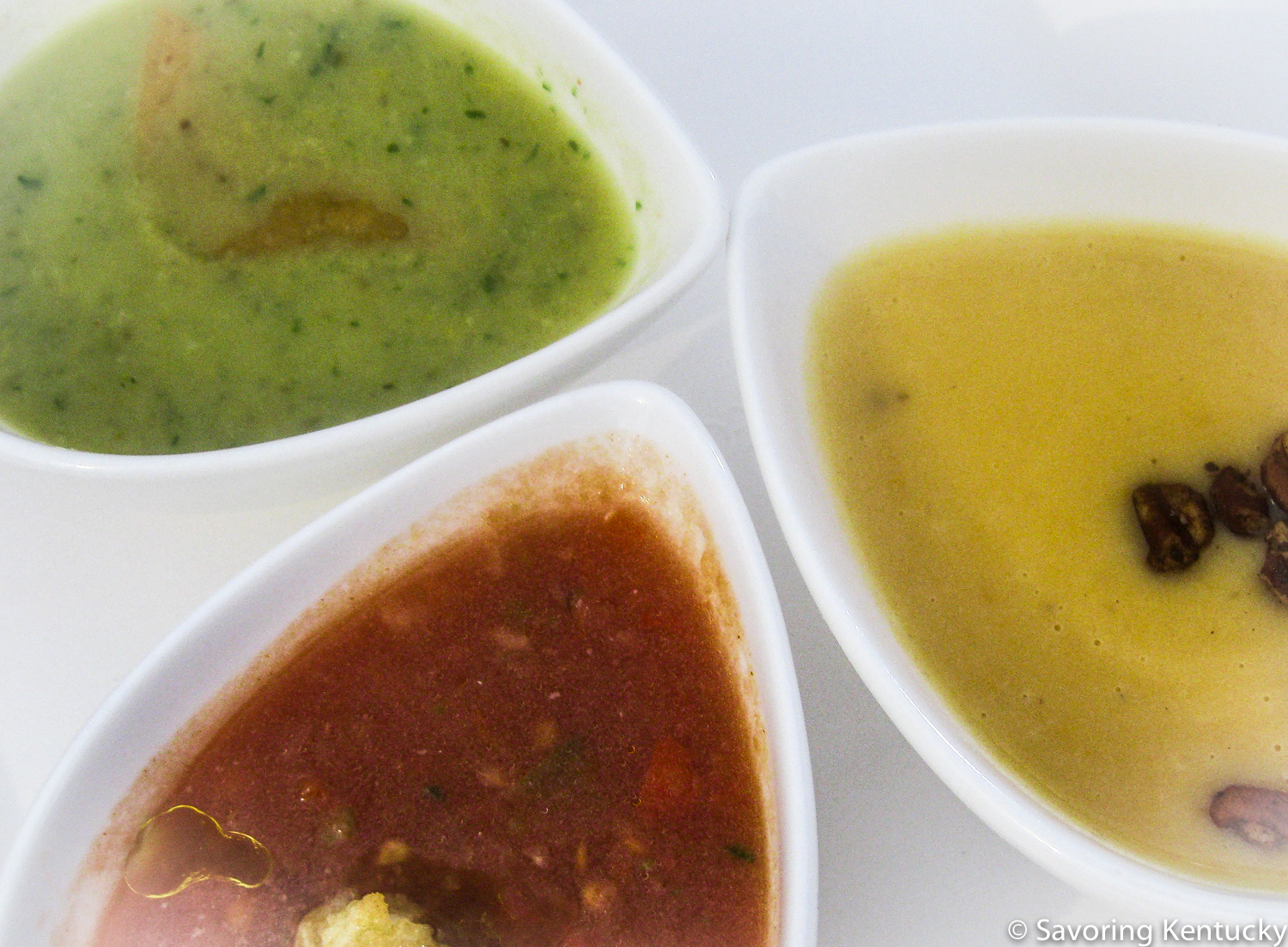 "Three Chimneys" Trio of Smoked Soups, clockwise from bottom left: Chilled hickory-smoked tomato gazpacho, chili-smoked summer squash puree, and bourbon barrel-smoked sweet potato and sorghum bisque
