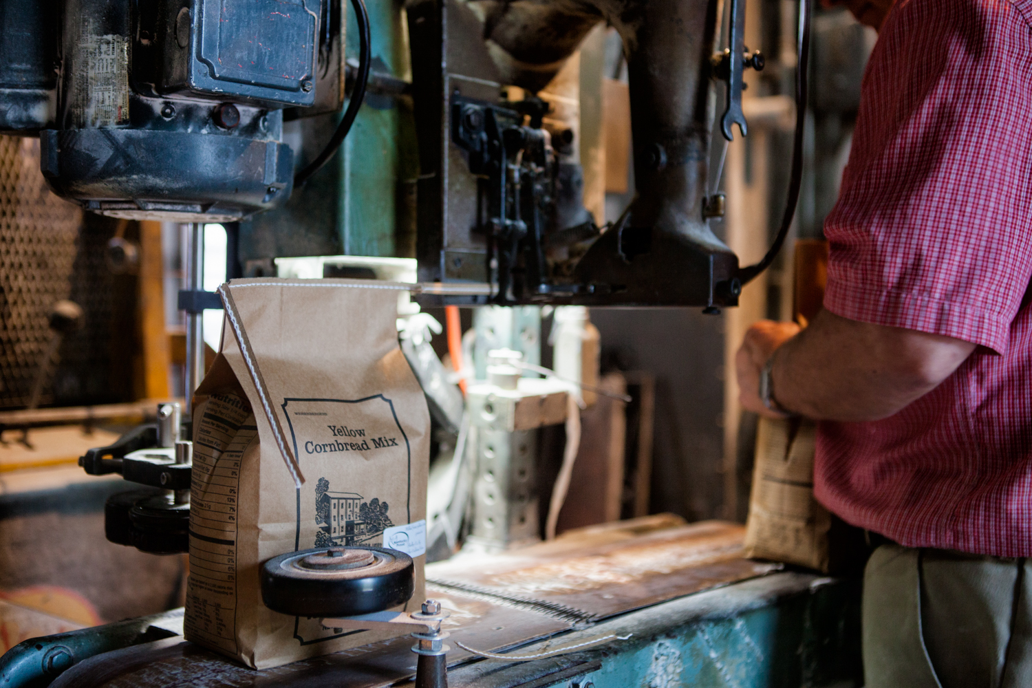 Mac Weisenberger packages Yellow Cornbread Mix (Mondays are for yellow corn!) at historic Weisenberger Mill near Midway, Kentucky. Photograph by Sarah Jane Sanders