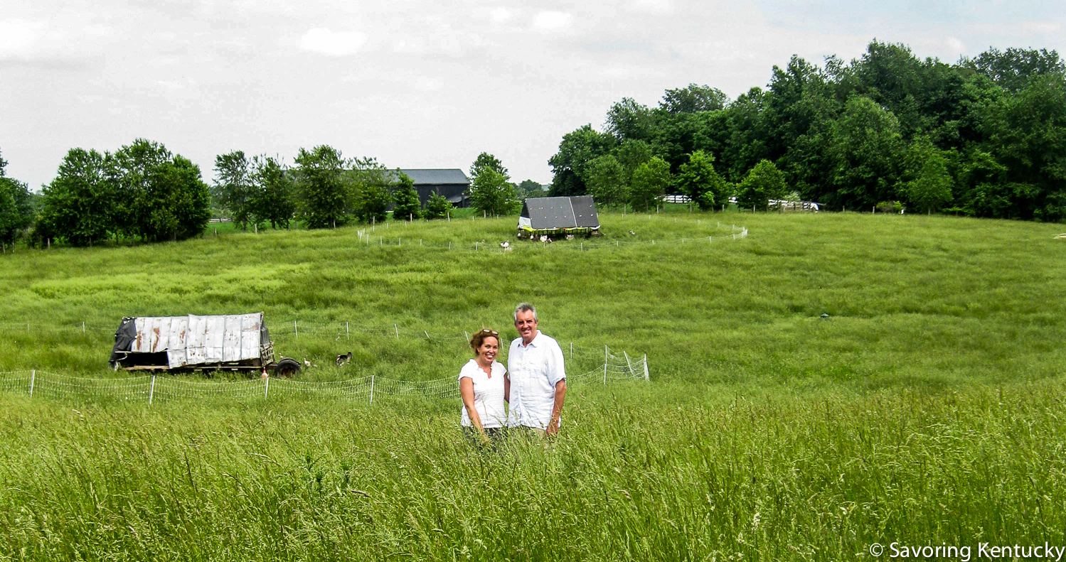Grass matters at Elmwood Stock Farm, and grass matters to us eaters. Ann Bell Stone and Mac Stone stand in their early summer grasses, chicken tractors behind them, at this priceless Scott County farm. One more thing: world class photographer Sarah Jane Sanders produced a splendid photo of these two standing in this field. We included that photo, and 87 other SJS wonders, in Classic Kentucky Meals.