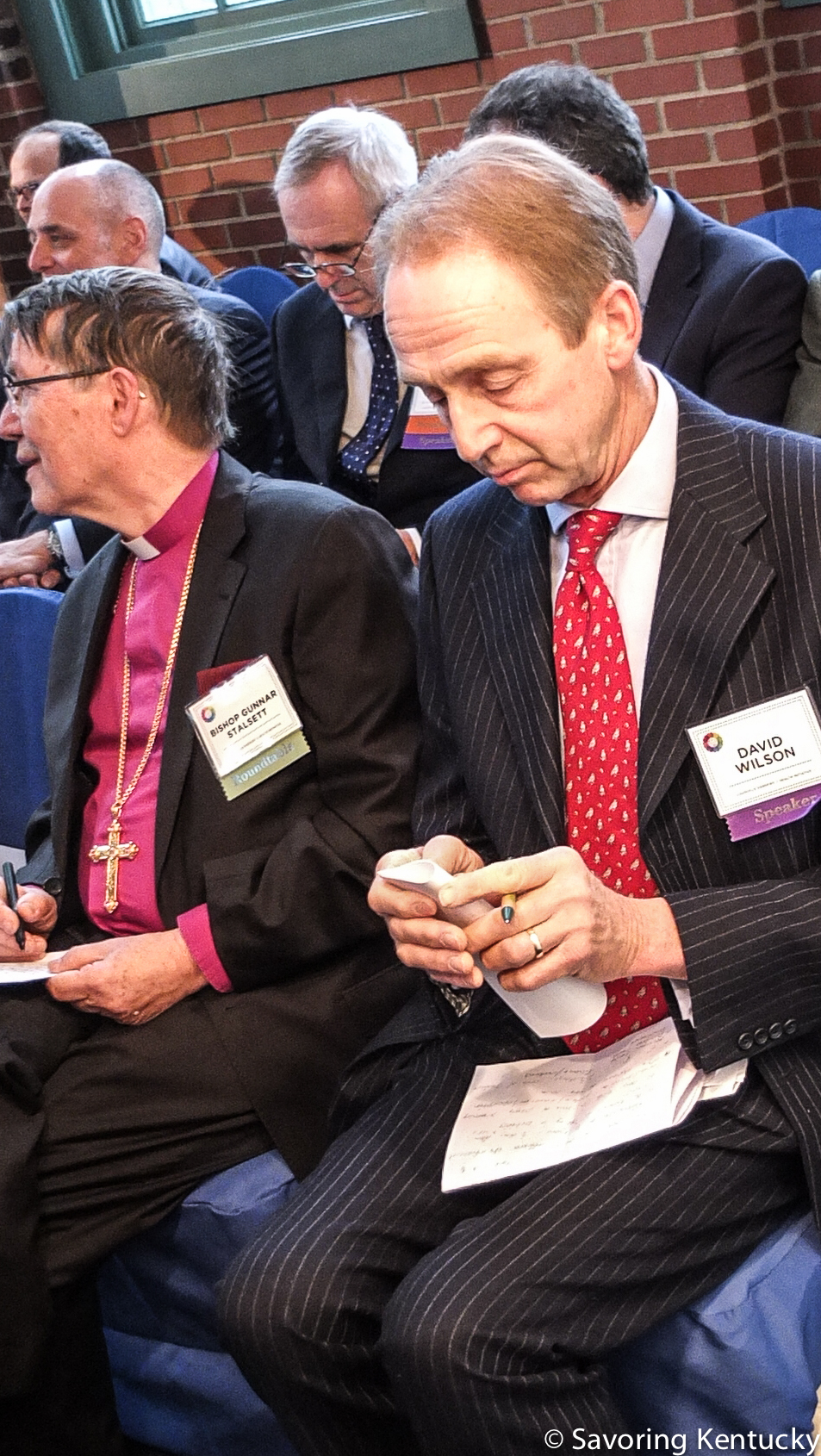 David Wilson, front right, and others prepare for their three-minute "Igniter" speeches at Louisville's Harmony and Health Initiative.