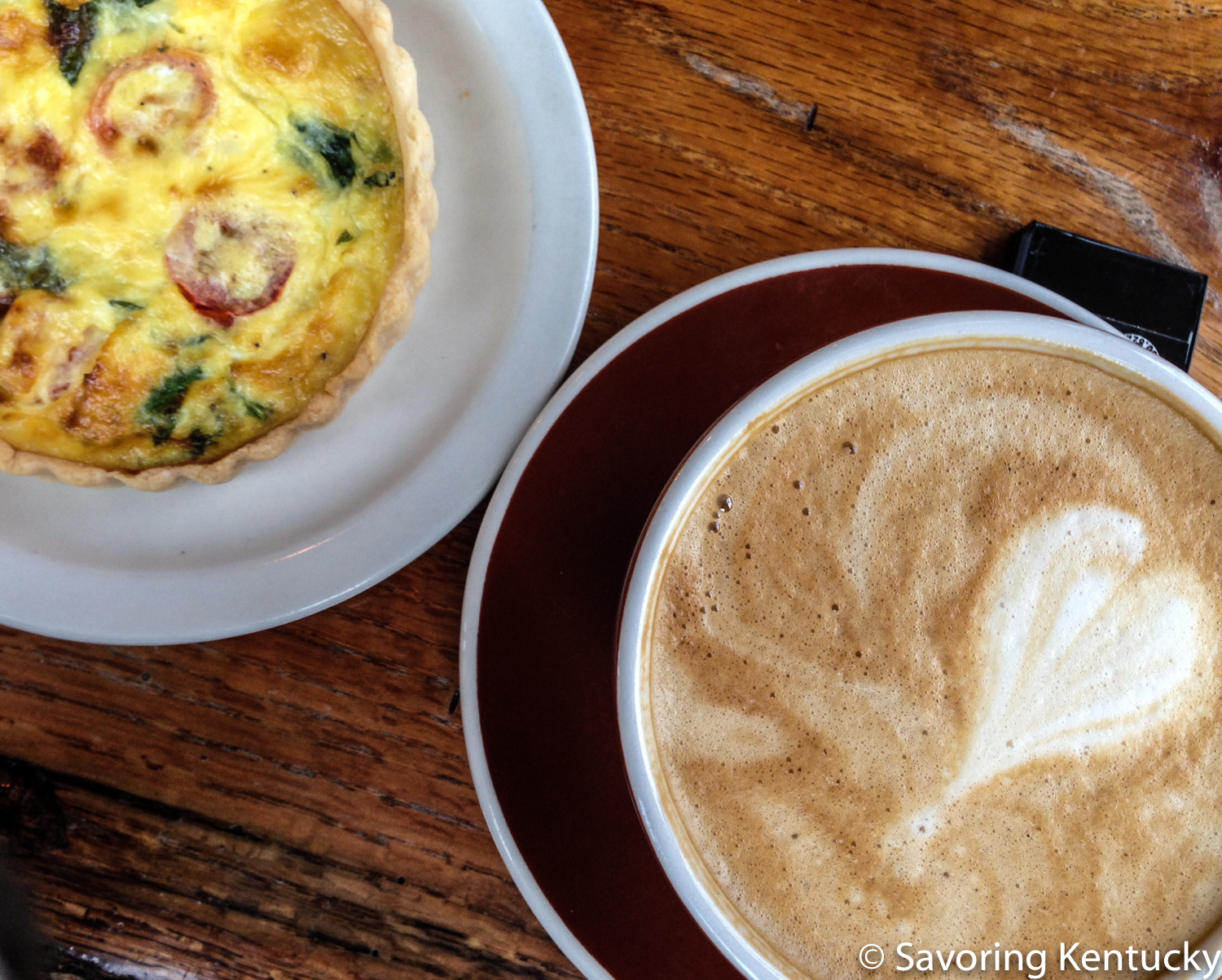 Quiche and breve latte at Daily Offerings Coffee Roastery . The quiche and all pastries are gluten-free and made in house.