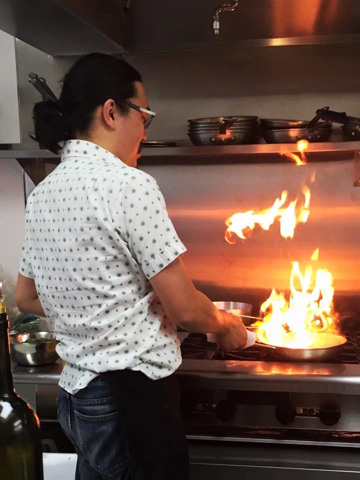 Dan Wu , Culinary Evangelis t, cooking with fire at Pasta Garage .