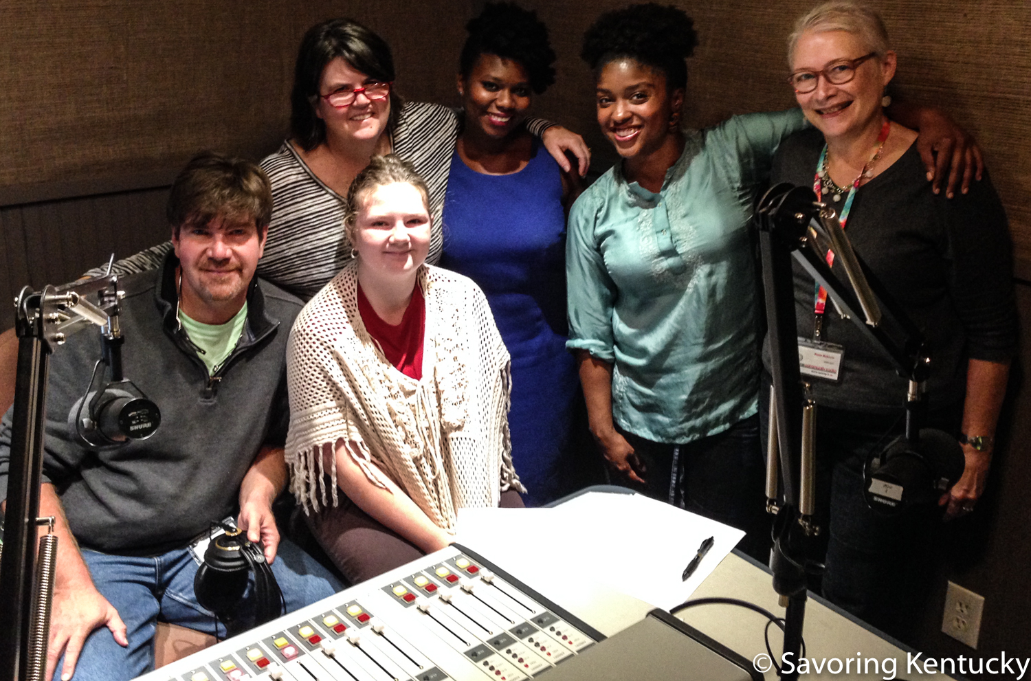 Co-hosts and guests at Hot Water Cornbread: Kentucky Food Radio, October 2015. From left, co-hosts Chris and Ouita Michel with their daughter (seated), Willa, and show guests Ashley Smith and Lacreesha Berry, co-host Rona Roberts.
