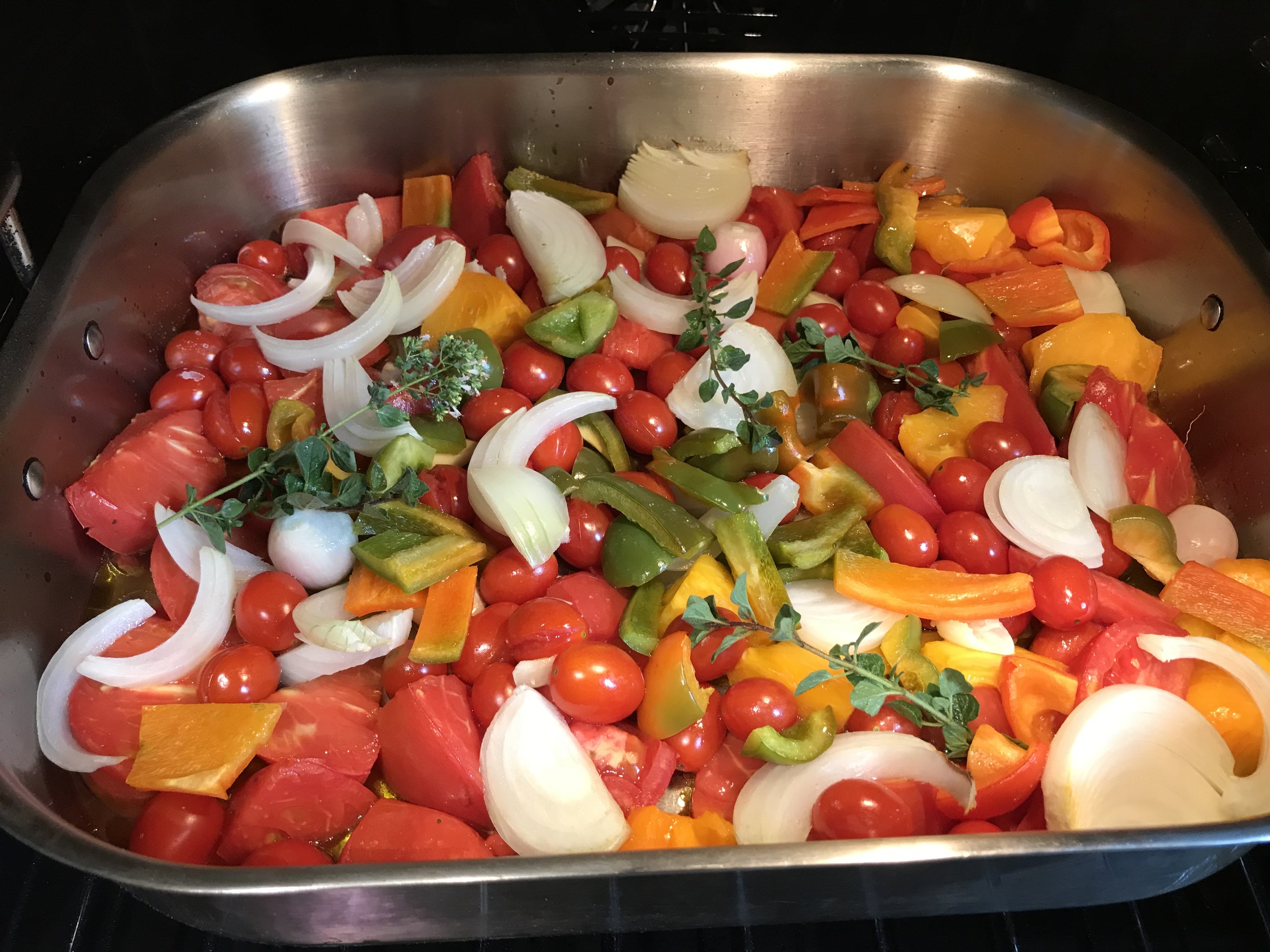 Gourmandistan’s stupendously easy and scrumptious Roasted Tomato Sauce as it enters the oven. Nearly all these ingredients are home grown, including Handsome Younger Brother’s heirloom tomatoes and peppers and the Best Man’s Campsie garlic, oregano and shallots.
