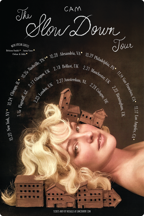 Promotional poster for The Slow Down Tour featuring a woman with blonde curly hair and model houses, with tour dates from October 24 to November 4 across various cities including Nashville, Glasgow, Belfast, Amsterdam, Cologne, and Birmingham.