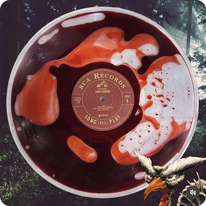 Vinyl record with swirl of red, black, and white paint on label and background, featuring a forest scene with trees and a deer head illustration.