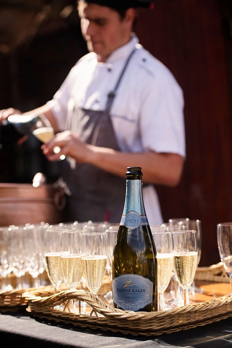 student chef michael farrell serving kleine zalze brut