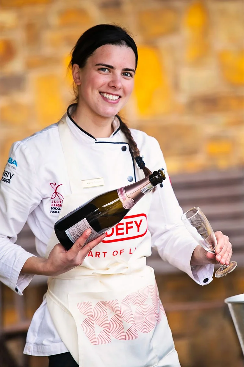 student chef mikha sabatta serving wine